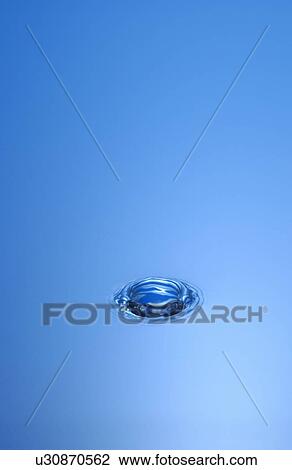 Stock Image - Water drop hitting surface. Fotosearch