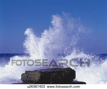 Stock Image - Waves crashing against rock, Fukuoka Prefecture, Kyushu, Japan. Fotosearch