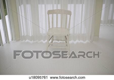 Stock Image - White chair in white room. Fotosearch