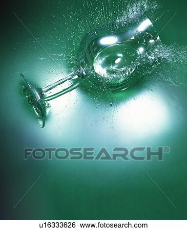 Stock Photograph - Wineglass dropped into water. Fotosearch