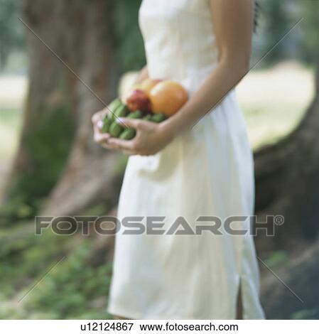 Stock Photo - Woman carrying fruits. Fotosearch