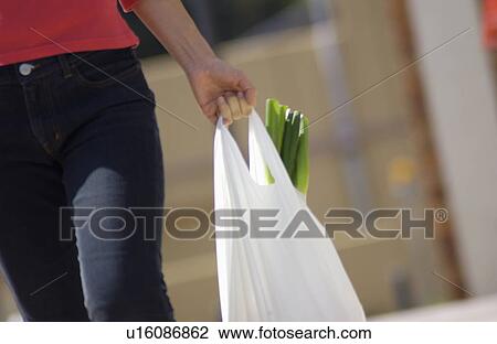 Woman carrying grocery View Large Photo Image Stock Image - Woman carrying grocery. Fotosearch