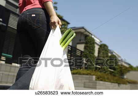 Stock Image - Woman carrying grocery. Fotosearch