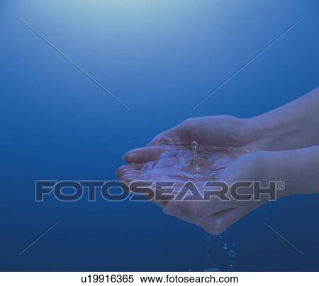 Stock Photography - Woman holding water in hands, blue background. Fotosearch