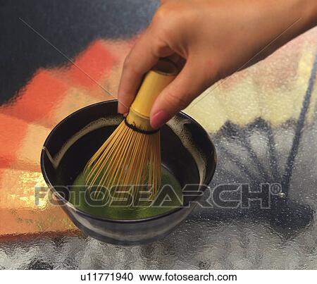 Stock Image - Woman performing tea ceremony. Fotosearch
