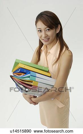 Young Woman Holding Piled Files View Large Photo Image Stock Image - Young Woman Holding Piled Files. Fotosearch