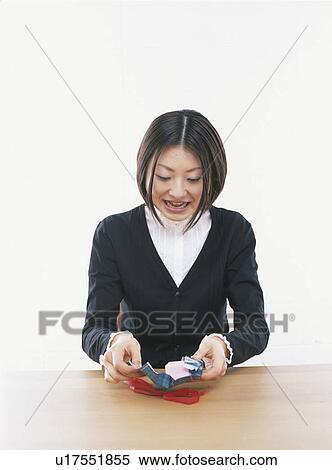 Young woman opening a gift box, smiling, white background View Large Photo Image Stock Photography - Young woman opening a gift box, smiling, white background. Fotosearch