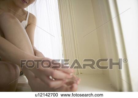 Young woman polishing toenails View Large Photo Image Stock Image - Young woman polishing toenails. Fotosearch