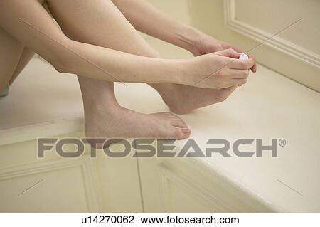 Young woman polishing toenails View Large Photo Image Stock Image - Young woman polishing toenails. Fotosearch