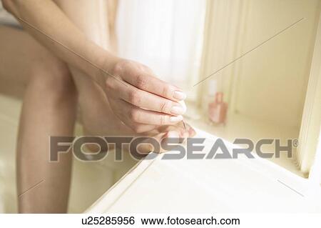 Young woman polishing toenails View Large Photo Image Stock Photograph - Young woman polishing toenails. Fotosearch