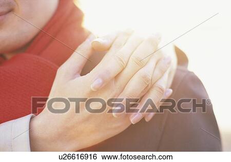 Young woman putting her hands on man's shoulder, close up View Large Photo Image Stock Photograph - Young woman putting her hands on man's shoulder, close up. Fotosearch
