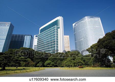 Stock Image - A garden and the Shiodome building group in Minato, Tokyo, Japan. Fotosearch