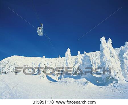 Stock Photo - Cable car in a snow-covered landscape in Yamagata, Japan. Fotosearch