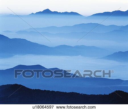 Stock Photo - Clouds shrouding a mountain range. Fotosearch