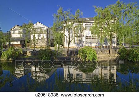 Stock Photograph - Houses along the riverbank in Kurashiki, Okayama Prefecture, Japan. Fotosearch