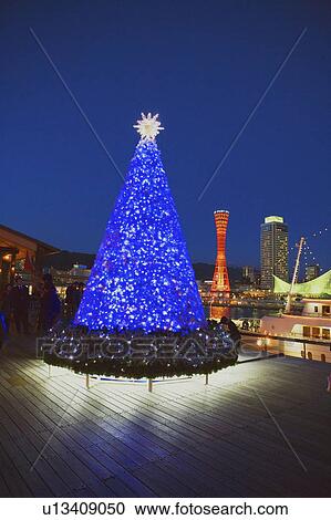 Stock Image - Night time view of a Christmas tree in the Kobe harbor, Hyogo Prefecture, Japan. Fotosearch