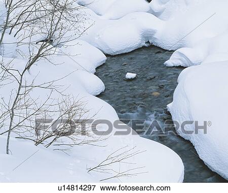 Stock Photo - River banks covered in snow. Fotosearch