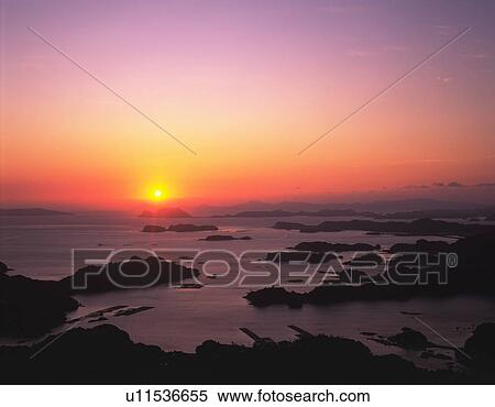 Stock Photography - Setting sun over the ocean, Nagasaki Prefecture, Japan. Fotosearch