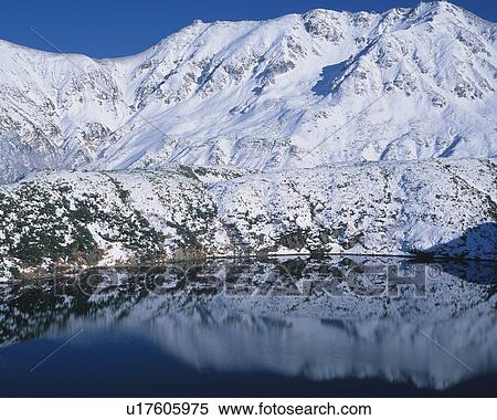 Snow-covered mountain and lake View Large Photo Image Stock Photography - Snow-covered mountain and lake. Fotosearch
