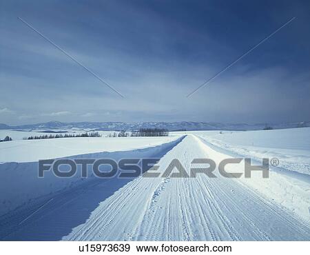 Stock Photo - Snowy road in Hokkaido, Japan. Fotosearch