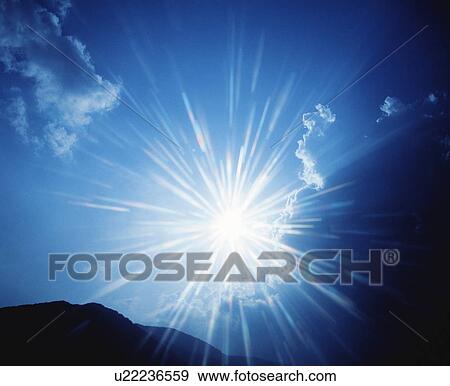 Stock Photo - Solar light against a blue sky. Fotosearch
