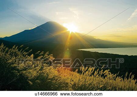 Sun setting behind Mt. Fuji, Yamanashi Prefecture, Japan View Large Photo Image Stock Photograph - Sun setting behind Mt. Fuji, Yamanashi Prefecture, Japan. Fotosearch