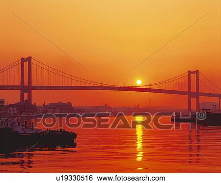 Stock Photograph - Wakato Bridge and the morning sun, Kitakyushu, Japan. Fotosearch