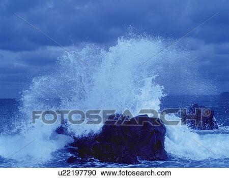 Wave breaking against a rock, Fukuoka Prefecture, Japan View Large Photo Image Stock Image - Wave breaking against a rock, Fukuoka Prefecture, Japan. Fotosearch