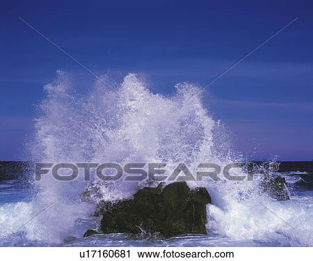 Stock Image - Wave crashing against rock, Genkainada, Fukuoka Prefecture, Japan. Fotosearch