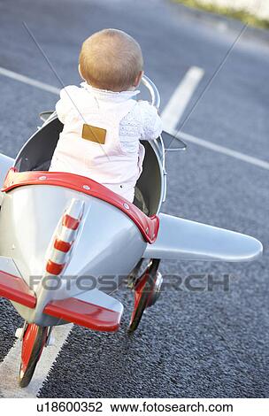 Baby Girl Riding In Toy Aeroplane View Large Photo Image Stock Image - Baby Girl Riding In Toy Aeroplane. Fotosearch