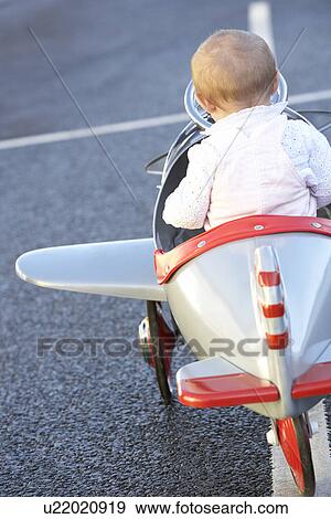 Baby Girl Riding In Toy Aeroplane View Large Photo Image Stock Photo - Baby Girl Riding In Toy Aeroplane. Fotosearch