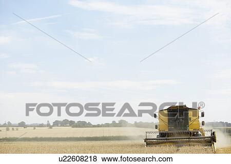 Stock Photo - Combine Harvester Working In Field. Fotosearch