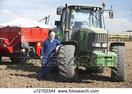 Driver Standing In Front Of Tractor View Large Photo Image Picture - Driver Standing In Front Of Tractor. Fotosearch