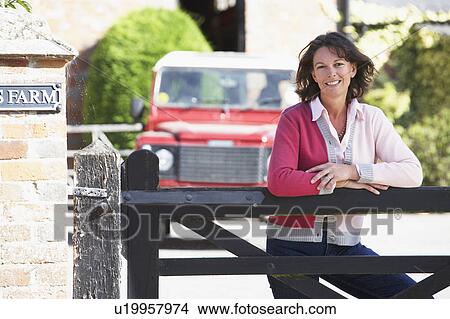 Farmer's Wife Looking Over Farm Gate View Large Photo Image Picture - Farmer's Wife Looking Over Farm Gate. Fotosearch