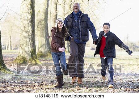 Stock Photo - Father And Children On Autumn Walk. Fotosearch