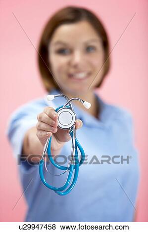 Stock Photo - Female Doctor Holding Stethescope. Fotosearch