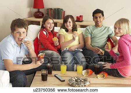 Stock Photograph - Group Of Children Eating Burgers At Home. Fotosearch