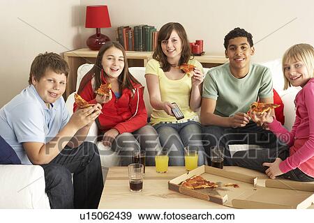 Stock Photo - Group Of Children Eating Pizza Watching TV. Fotosearch