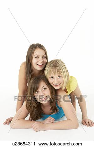 Stock Image - Group Of Three Young Girls In Studio. Fotosearch