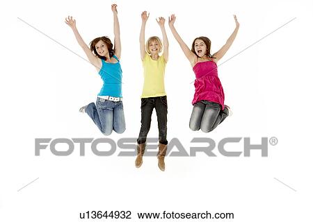 Stock Image - Group Of Three Young Girls Leaping In Air. Fotosearch