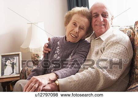 Stock Photo - Loving Senior Couple Relaxing At Home. Fotosearch