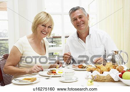Middle Aged Couple Enjoying Hotel Breakfast View Large Photo Image Stock Image - Middle Aged Couple Enjoying Hotel Breakfast. Fotosearch