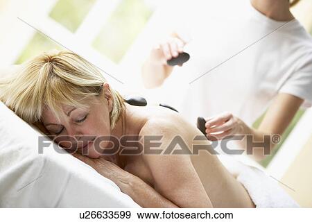 Middle Aged Woman Enjoying Hot Stone Treatment View Large Photo Image Stock Photo - Middle Aged Woman Enjoying Hot Stone Treatment. Fotosearch