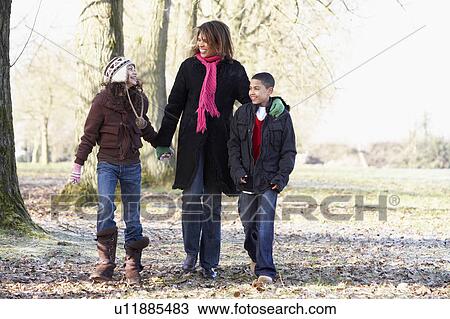 Stock Image - Mother And Children On Autumn Walk. Fotosearch