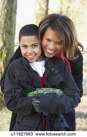 Stock Image - Mother And Son On Autumn Walk. Fotosearch