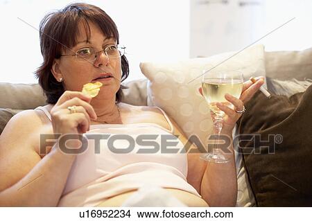Overweight Woman Relaxing On Sofa View Large Photo Image Picture - Overweight Woman Relaxing On Sofa. Fotosearch