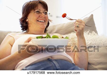 Overweight Woman Relaxing On Sofa View Large Photo Image Stock Photo - Overweight Woman Relaxing On Sofa. Fotosearch