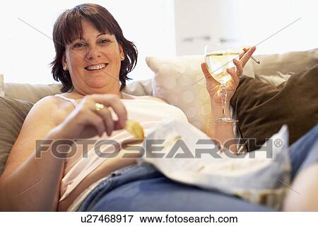 Overweight Woman Relaxing On Sofa View Large Photo Image Stock Photo - Overweight Woman Relaxing On Sofa. Fotosearch
