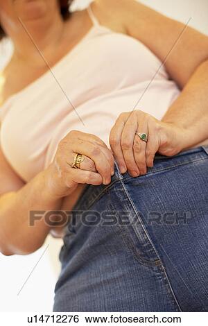 Overweight Woman Trying To Fasten Trousers View Large Photo Image Stock Photograph - Overweight Woman Trying To Fasten Trousers. Fotosearch