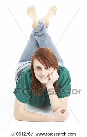 Portrait Of Smiling Teenage Girl Laying On Stomach View Large Photo Image Stock Photo - Portrait Of Smiling Teenage Girl Laying On Stomach. Fotosearch